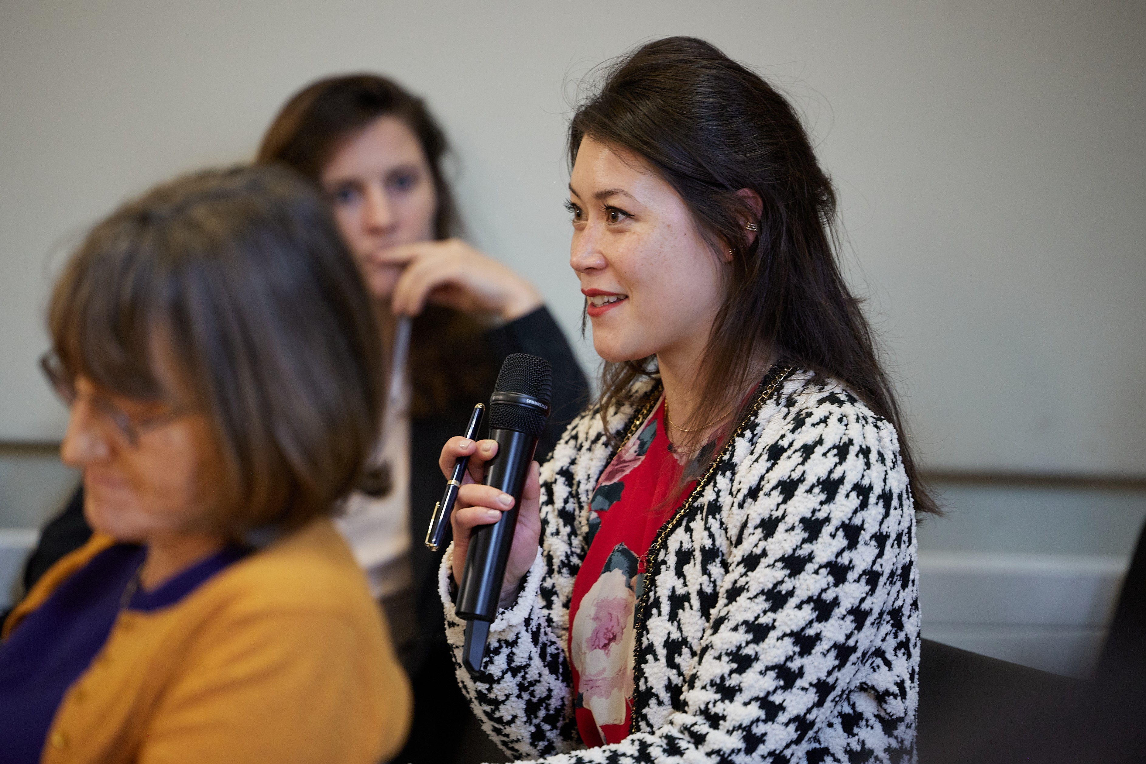 a member of the audience directing a question to the panel