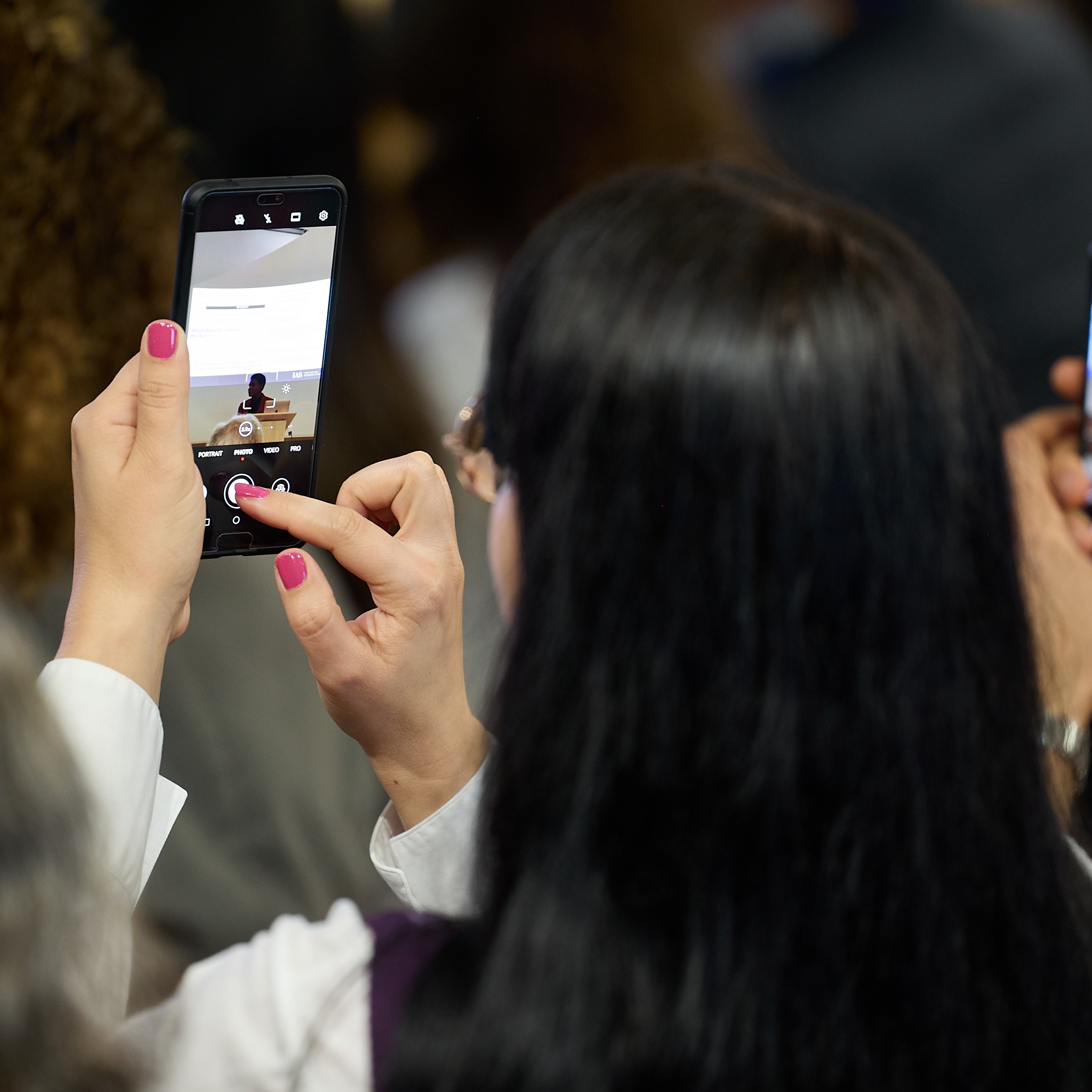 Decoration only; someone in the audience taking a photo from mobile phone - Photographer was Ian Wallman