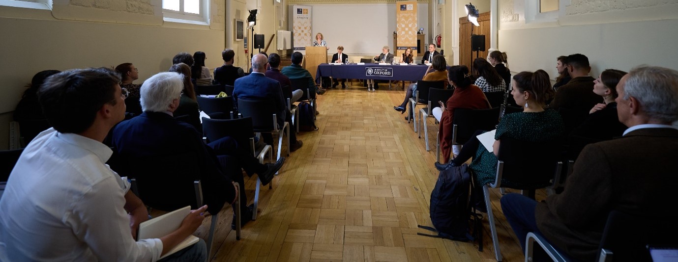 Rear view of the audience looking towards the panel