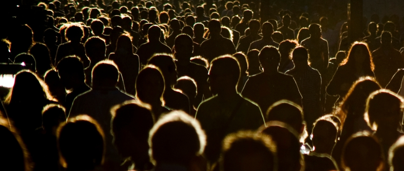 A see of people walking away from the camera