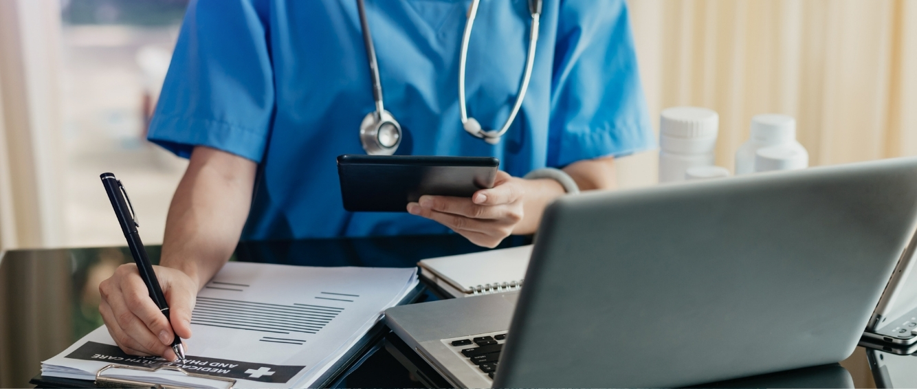 Health care worker doing paperwork at a desk