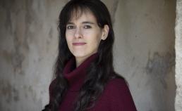 a profile picture of Dr Carissa Veliz against the backdrop of a granit building wall