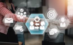 Stock image of a couple shaking hands behind hexagonal icons
