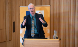 Josiah Ober speaking to an audience in the Levine Building Auditorium