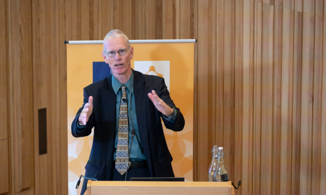 Josiah Ober speaking to an audience in the Levine Building Auditorium