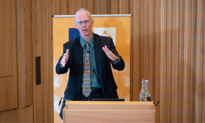 Josiah Ober speaking to an audience in the Levine Building Auditorium